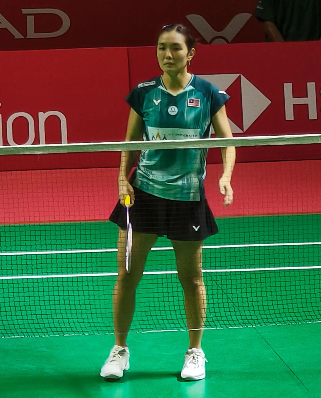 Lai Pei Jing in a green shirt standing on court with a racket at the Indonesia Open 2026