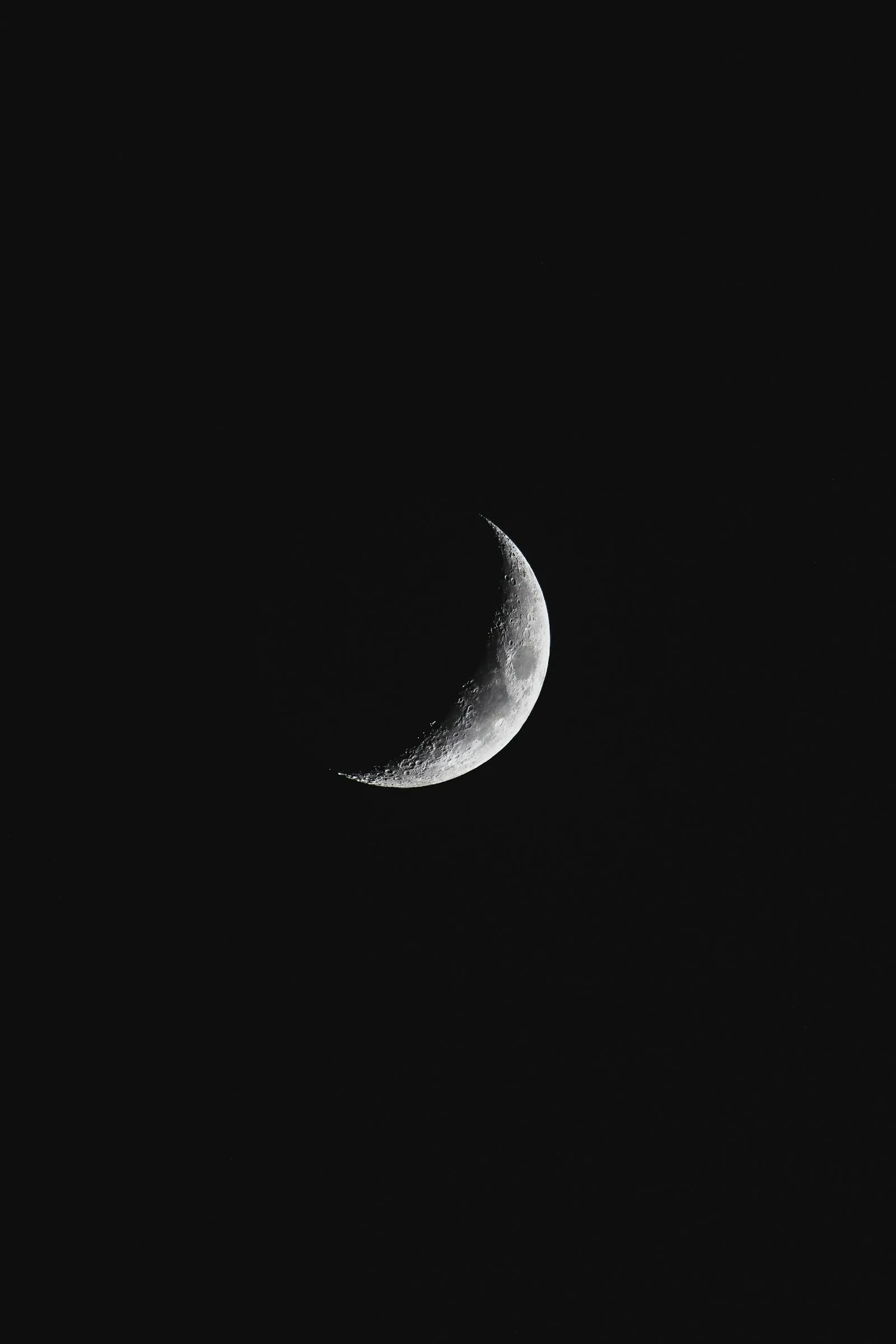 A crescent moon against a dark sky